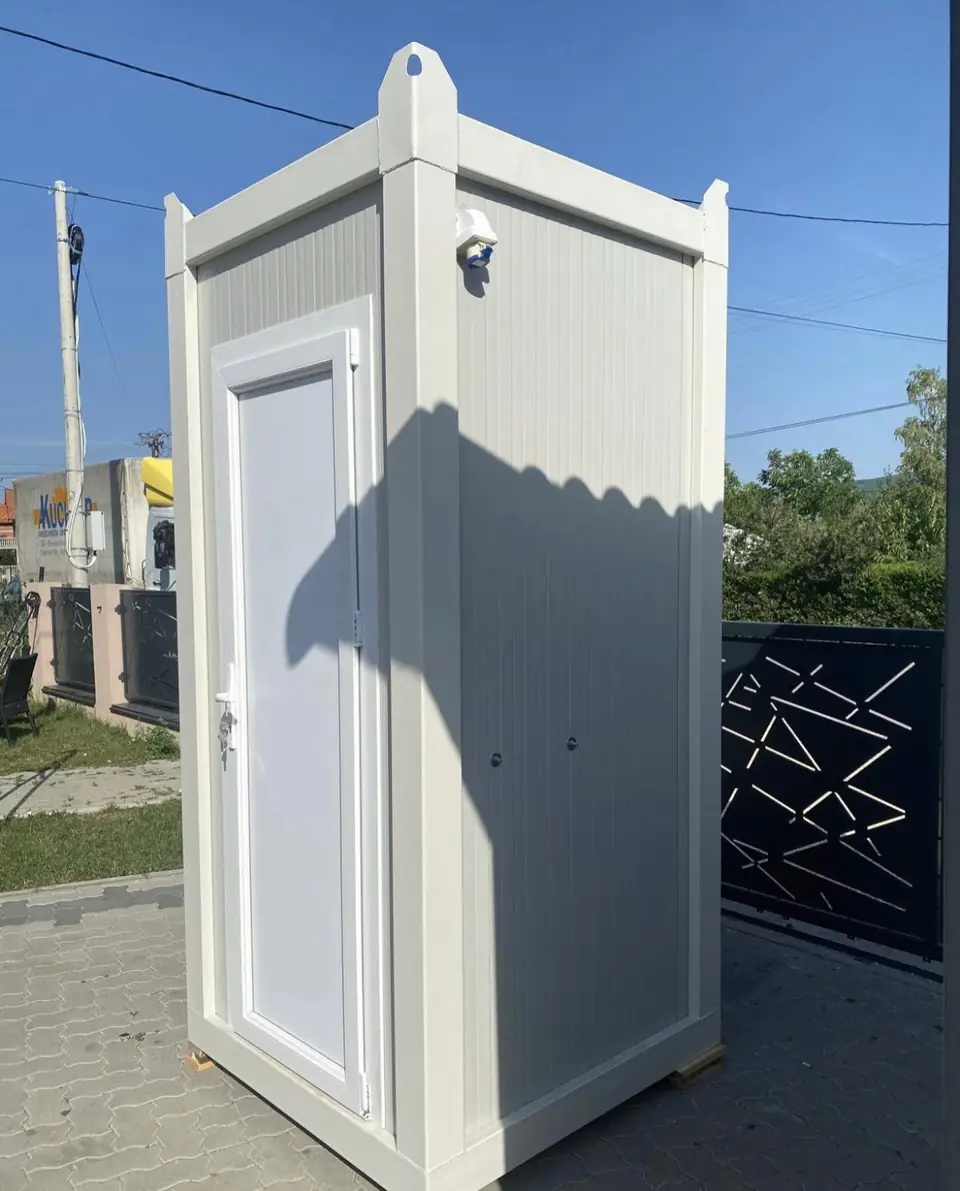White single-room luxury restroom cabin with a paneled door